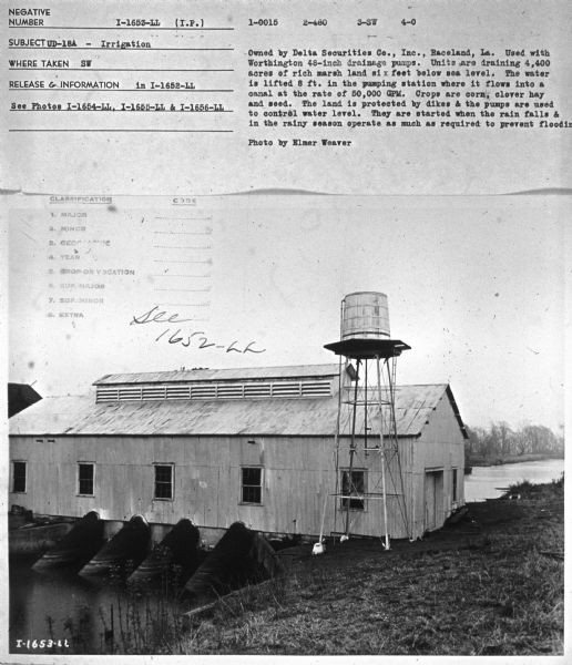Subject: "UD-18A — Irrigation." Where Taken: "SW." Information with photograph reads: "Owned by Delta Securities Co., Inc., Raceland, La. Used with Worthington 48-inch drainage pumps. Units are draining 4,400 acres of rich marsh land six feet below sea level. The water is lifted 8 ft. in the pumping station where it flows into a canal at the rate of 50,000 GPM. Crops are corn, clover hay and seed. The land is protected by dikes & the pumps are used to control water level. They are started when the rain falls & in the rainy season operate as much as required to prevent flooding. Photo by Elmer Weaver."