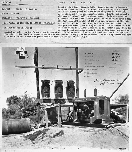 Subject: "UD-24 — Irrigation." Where Taken: "SW." Information with photograph reads: "Owned by Carl Lane, Klamath Falls, Oregon who owns a 960-acre farm near Casa Grande, Ariz. which is operated by C.R. Sturgeon. The UD-24 diesel power unit has taken the place of a 125-hp. motor which had to be disconnected because drouths had caused a shortage of hydraulically produced power. It is connected by 6 V-belts to a Peerless turbine pump. Water is taken from a well 600 feet deep with a lift of 180 feet and is pumped at the rate of 2300 to 2400 gals. per min., 24 hrs. a day, sufficient to irrigate 400 acres. The casing of the well is 20 inches in diameter and water is delivered thru an 18-in. outlet pipe. With the present Diesel operation ninety 2-inch syphon hoses are used as agaist seventy with the former electric operation. It takes approx. 9 gals. of Diesel fuel per hr. to operate the outfit. The UD-24 is portable and can be transported to any place where needed. It has 6 cylinders equipped with radiator fan clutch and power take-off develops 180 hp. at 1375 r.p.m."