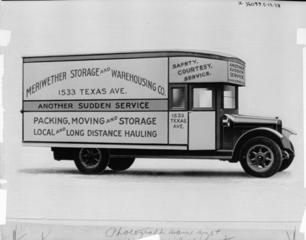 Passenger side view of a delivery truck. Sign painted on side reads, in part: "Meriwether Storage and Warehousing Co."