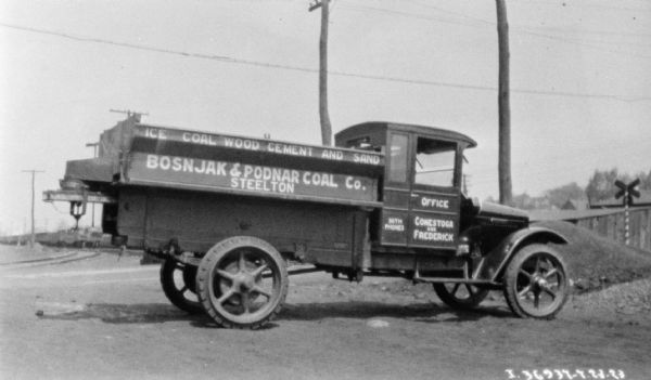 View towards the passenger side of a coal delivery truck. The sign painted on the side reads: "Bosnjak & Podnar Coal Co."