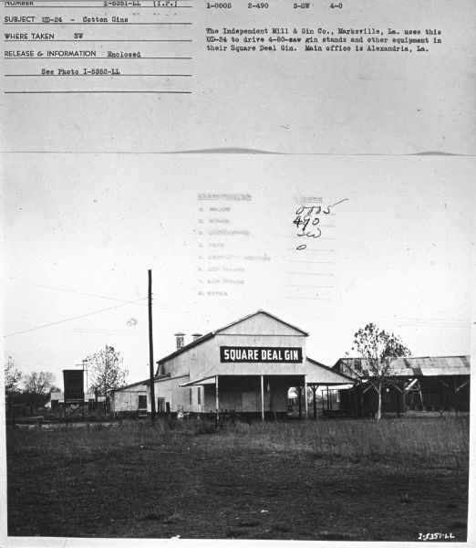 View across field towards the Square Deal Gin. Subject: "UD-24 — Cotton Gins." Where Taken: "SW." Information with photograph reads: "The Independent Mill & Gibn Co., Marksville, La. uses this UD-24 to drive 4-80-saw gin stands and other equipmnt in their Square Deal Gin. Main office is Alexandria, La."	