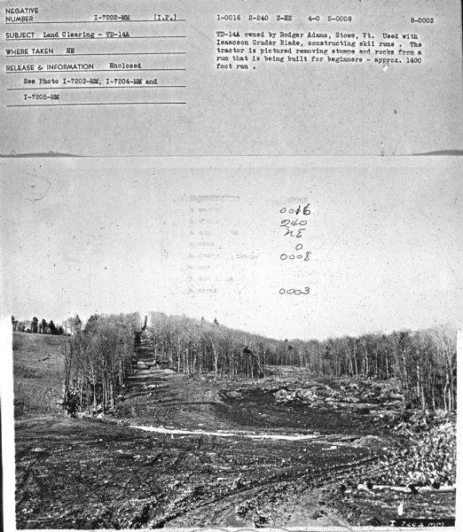 Subject: "Land Clearing — TD-14A." Where Taken: "NE." Information with photograph reads: "TD-14A owned by Rodger Adams, Stowe, Vt. Used with Isaacson Grader Blade, constructing skii[sic] runs. The tractor is pictured removing stumps and rocks from a run that is being built for beginners - approx. 1400 foot run."