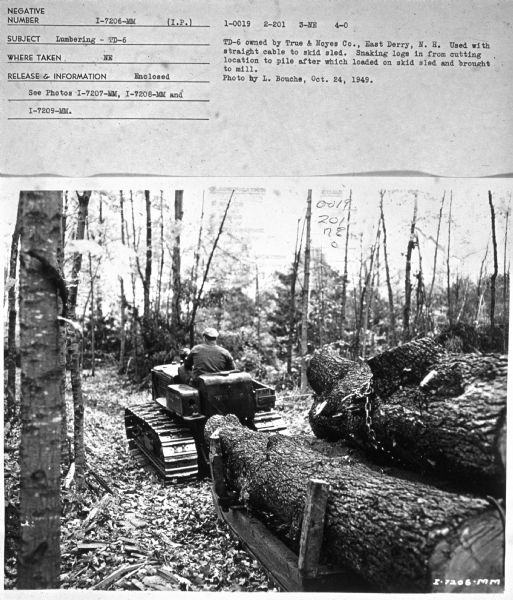 Subject: "Lumbering — TD-6." Where Taken: "NE." Information with photograph reads: "TD-6 owned by True & Noyes Co., East Derry, N.H. Used with straight cable to skid sled. Snaking logs in from cutting location to pile after which loaded on skid sled and brought to mill. Photo by L. Bouche, Oct. 24, 1949."