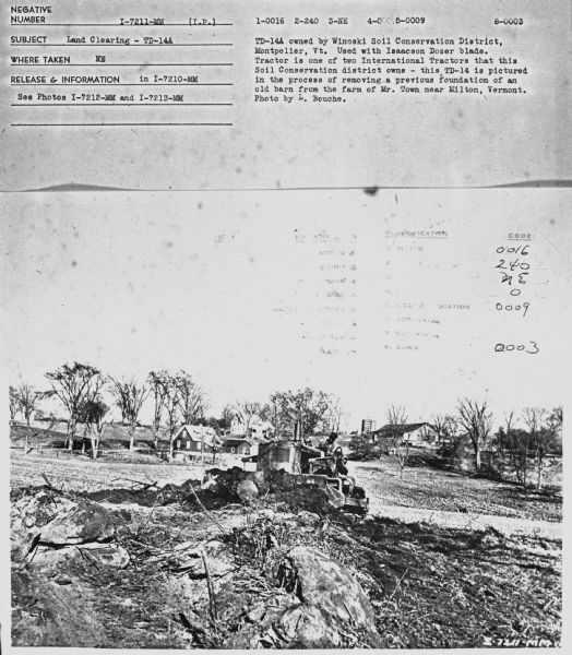 Subject: "Land Clearing — TD-14A." Where Taken: "NE." Information with photograph reads: "TD-14A owned by Winoski Soil Conservation District, Montpelier, Vt. Used with Isaacson Dozer blade. Tractor is one of two International Tractors that this Soil Conservation district owns — this TD-14 is pictured in the process of removing a previous foundations of an old barn from the farm of Mr. Town near Milton, Vermont. Photo by L. Bouche."