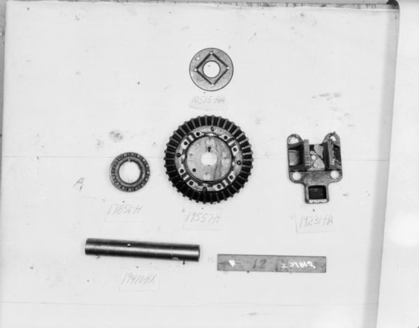 Machine parts on a white background, with numbers written near each part.