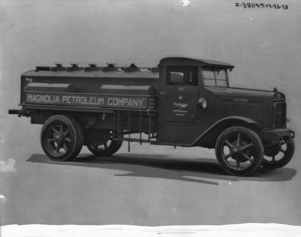 Passenger side view of a Magnolia Petroleum Company truck. The sign on the passenger side door reads: "Magnotone The Dependable Lubricant."