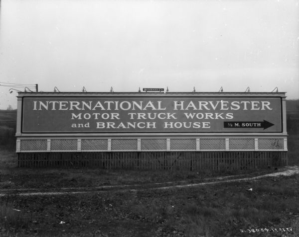 A large billboard reads: "International Harvester Motor Truck Works and Branch House, 1/2 M. South."