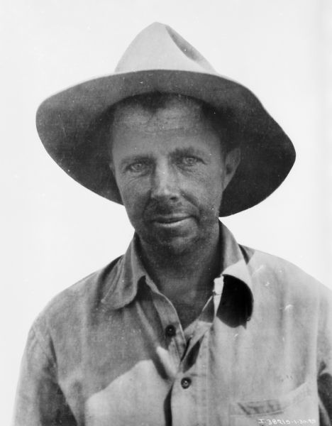 Portrait of Baron Bror Frederik von Blixen in Tanganyika, Africa. He is wearing a shirt and hat.