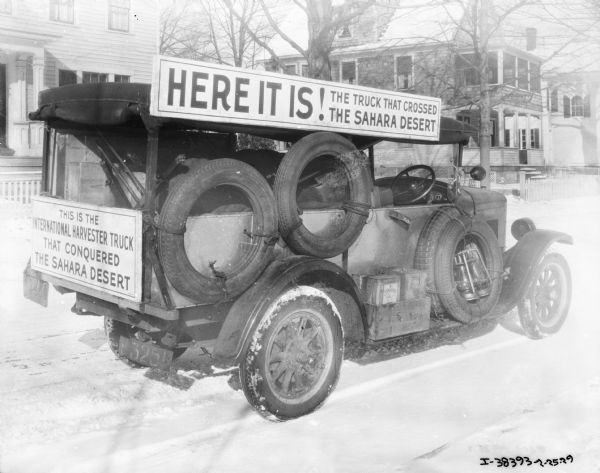 The truck that crossed the Sahara parked on a snowy street, with a sign that reads: "Here it is!"