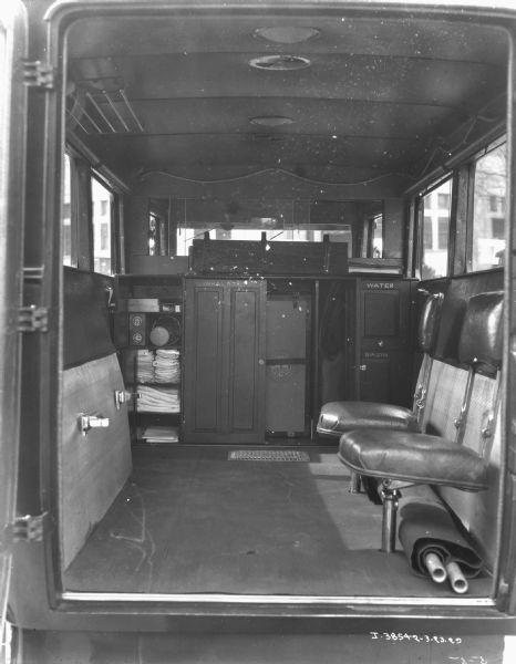 View of the back of an ambulance through the open doors.