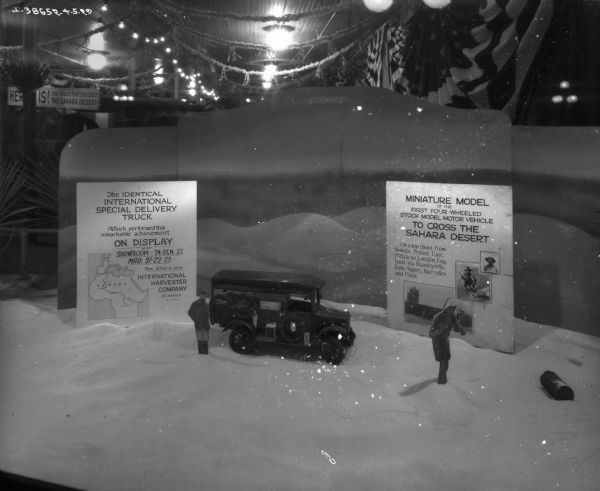 A miniature model with a sign that reads, in part: "Miniature Model of the First Four-Wheeled Stock Model Motor Vehicle to Cross the Sahara Desert."