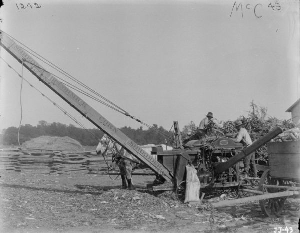 Men Using McCormick Corn Husker and Shredder | Photograph | Wisconsin ...