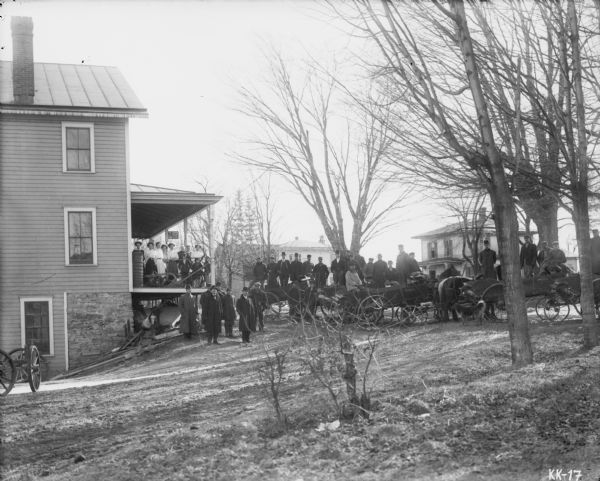 Large crowd in front of dealership, with products on dipslay, including horse-drawn manure spreaders. Sign in front: "Osgood US Standard Binghamton, NY."