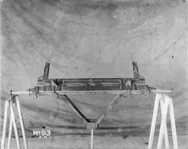 Wagon parts set up indoors on sawhorses at McCormick Works. Painted on the section of wagon are the words: "Columbus Wagon Co., Chicago, Ill."