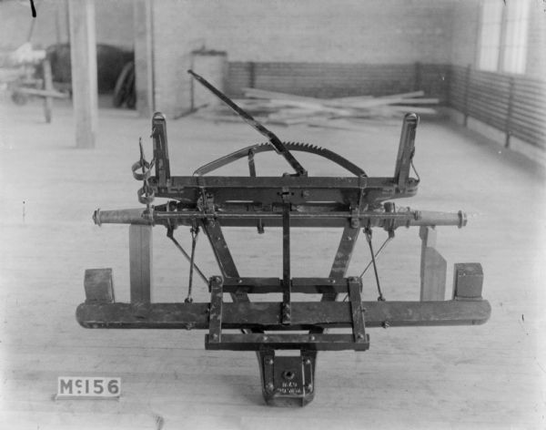 Weber wagon part set up on blocks indoors at McCormick Works.