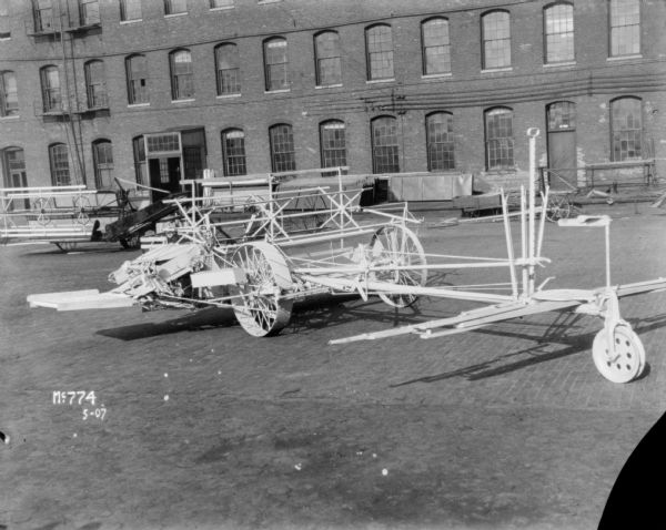 Push binder header outdoors at McCormick Works. Other machines are in the background.
