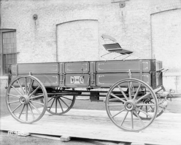 Weber wagon with wagon box set up outdoors on a wooden pallet at McCormick Works.
