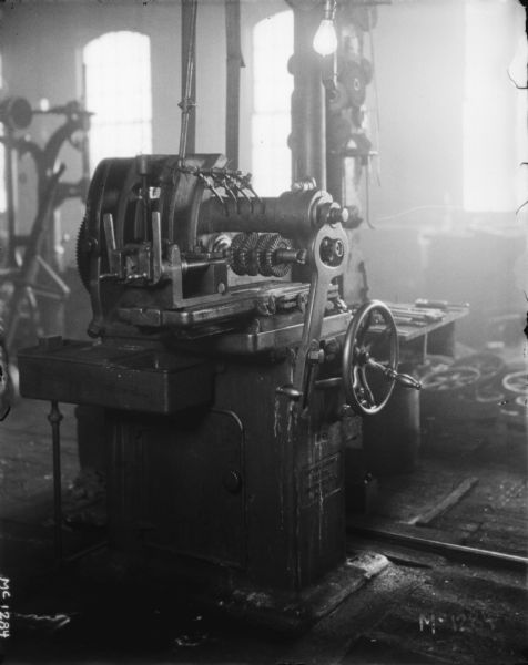 Lathe indoors at McCormick Works. Windows are in the background.