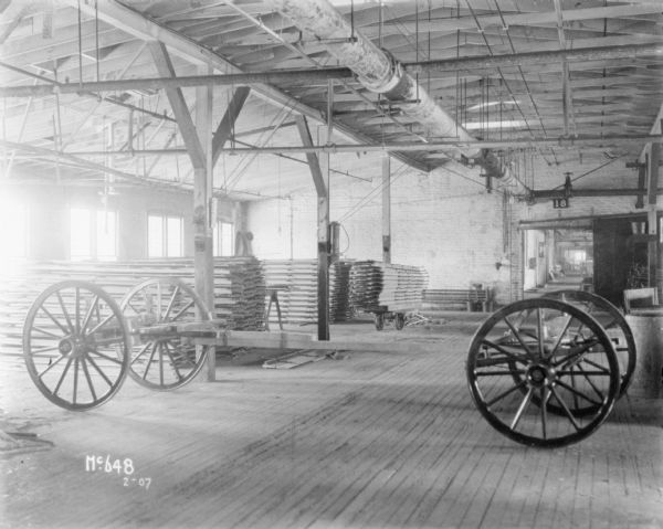 Wagon chassis inside a factory building.
