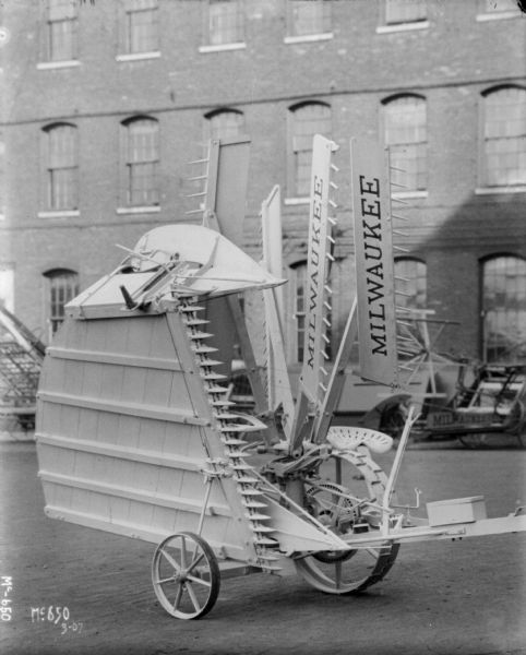 Milwaukee Reaper outdoors at McCormick Works. A brick factory building is in the background.