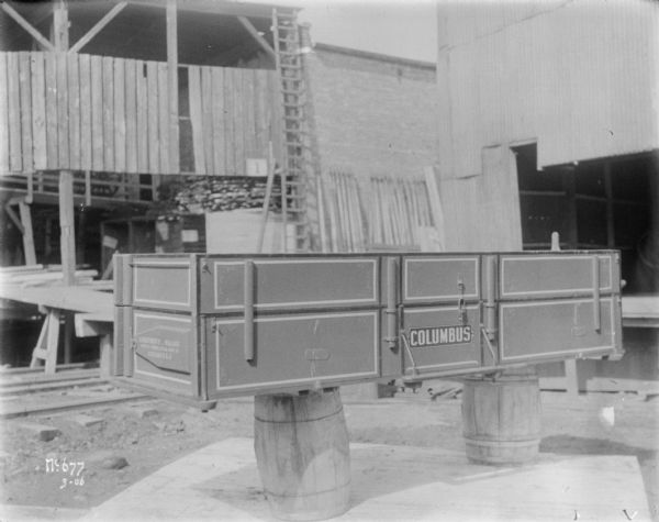 Columbus wagon box set up on a barrel at McCormick Works.
