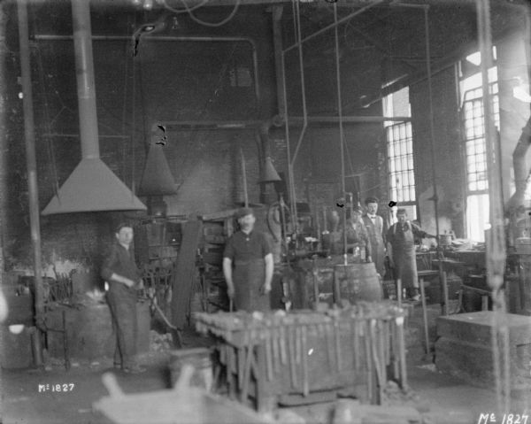 A group of men are posing indoors at McCormick Works.