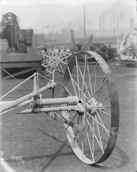 Close-up of a wheel on a Push Binder Header outdoors in a yard at McCormick Works.