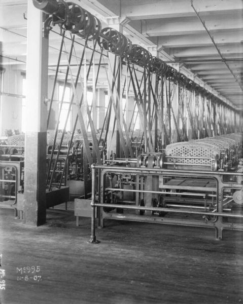View of a large factory room with machinery.
