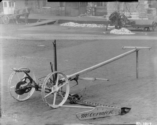 A horse-drawn mower in the yard at McCormick Works. In the background on the left is the horse-drawn photographer's wagon.