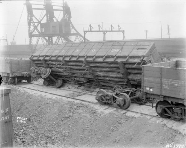 Slightly elevated view of a tipped over boxcar.