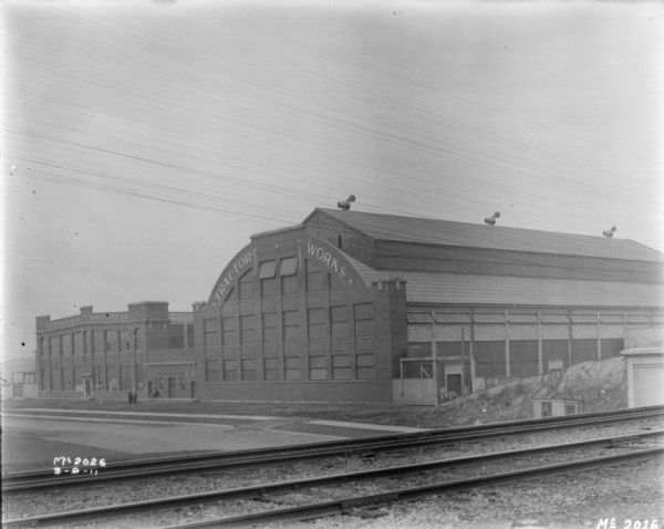 View across railroad tracks towards the Tractor Works building.