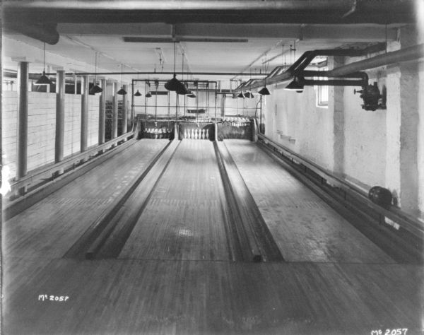 Interior view of bowling alley, with three lanes.