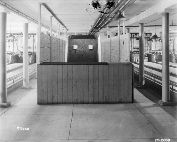 Interior view of the shooting gallery, with bowling alleys on the left and right.