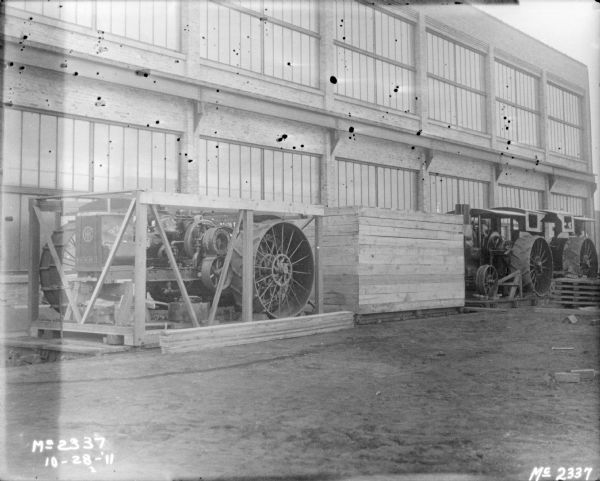 Tractors being crated for shipment are sitting outdoors at McCormick Works.