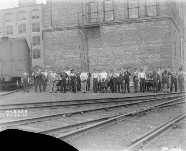 Group Of Employees In Front Of Plant Office Building | Photograph ...