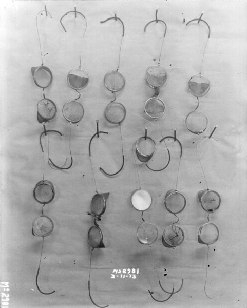Ten safety glasses showing damage to lenses.