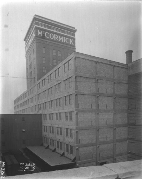 View from roof looking towards a building under construction. The new tower above the building has a sign that reads: "McCormick."