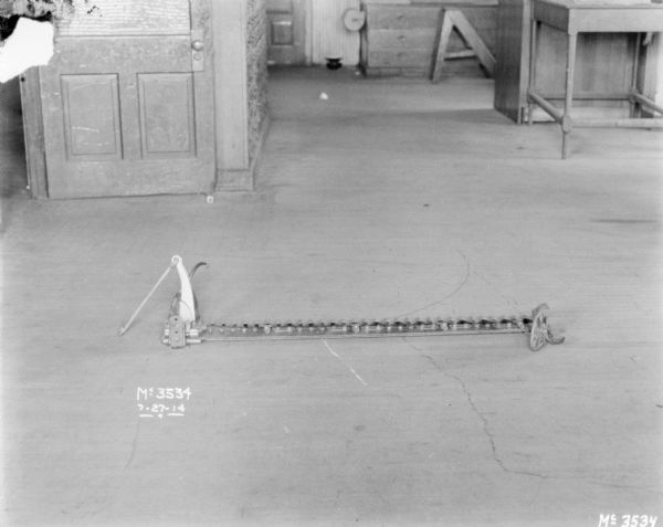 A blade factory part is on the floor of a factory floor.