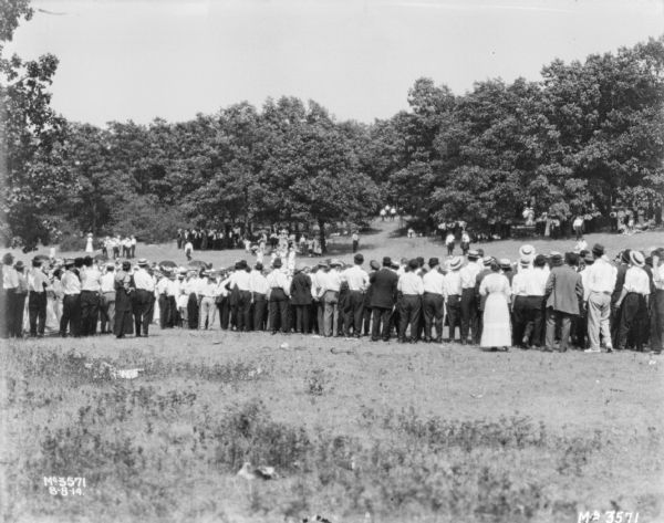 Large group of men and women meeting train for a picnic.