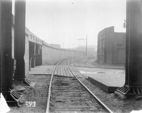 View down railroad tracks near elevated platform at McCormick Works.