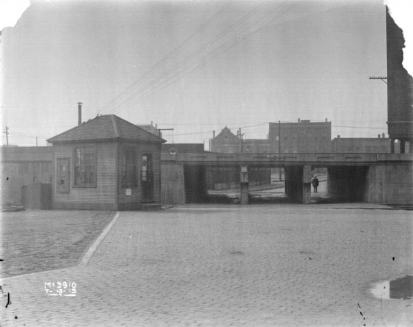 View of yard looking towards gatehouse near the elevated railroad tracks. The yard was used as a photo "studio" area.