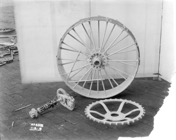 Wheels and parts set-up outdoors in the factory yard on the cobblestone. There is a backdrop behind.