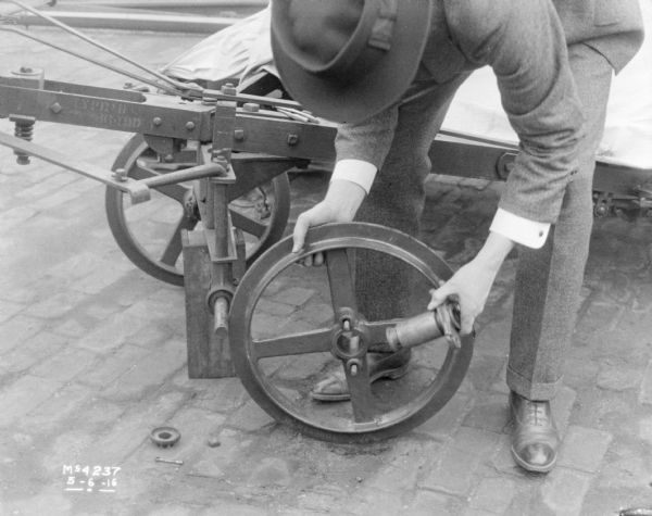 Man Mounting Wheel Onto Machine Photograph Wisconsin Historical Society