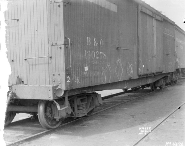 Rear view of a boxcar on railroad tracks.