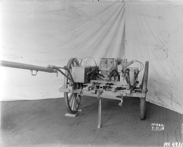 Gun Cart on factory floor surrounded by backdrops.
