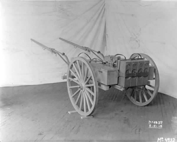 Gun Cart on factory floor surrounded by backdrops.