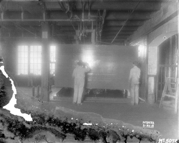 Men working on factory floor.