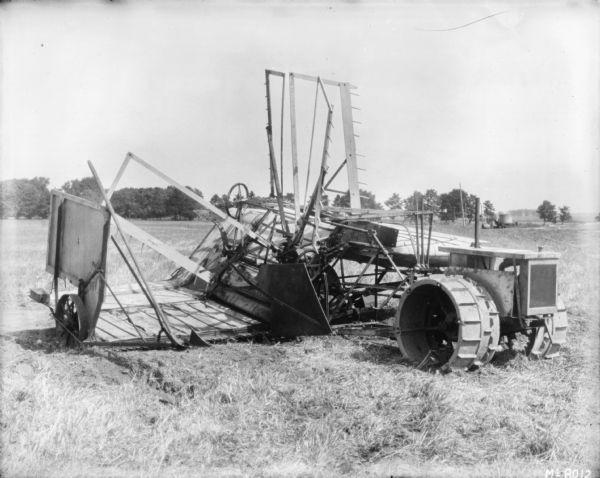 Tractor Drawn Reaper in field.