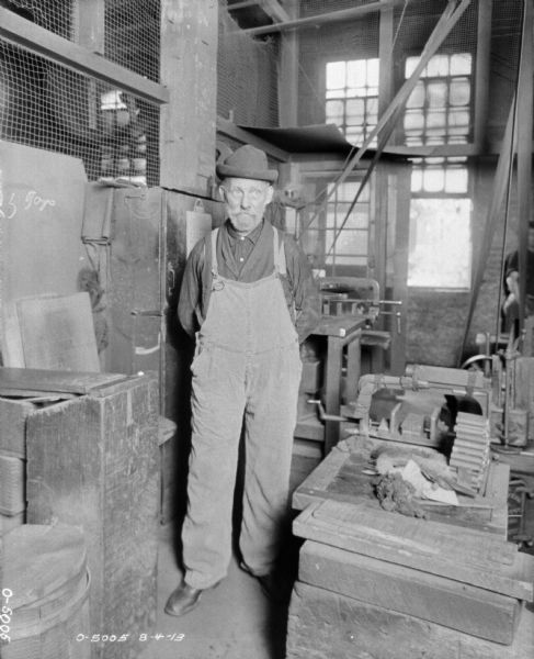 A man is standing in a manufacturing area.