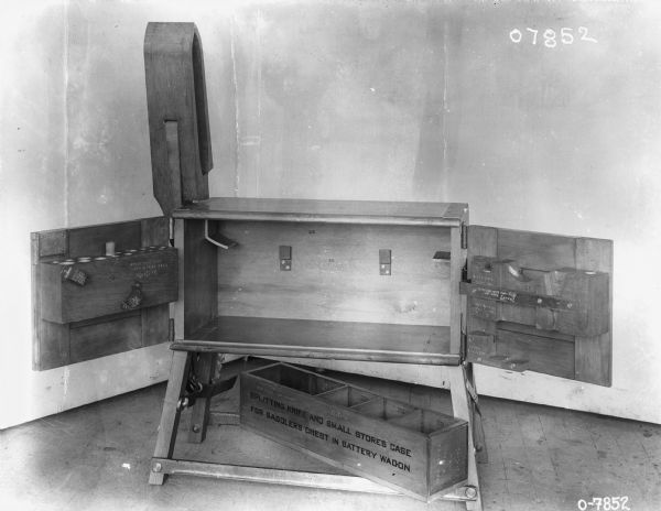 Chest is open, and text printed on a box reads: "Splitting knife and small stores case for saddlers chest in battery wagon." Other parts are stored inside the doors.
